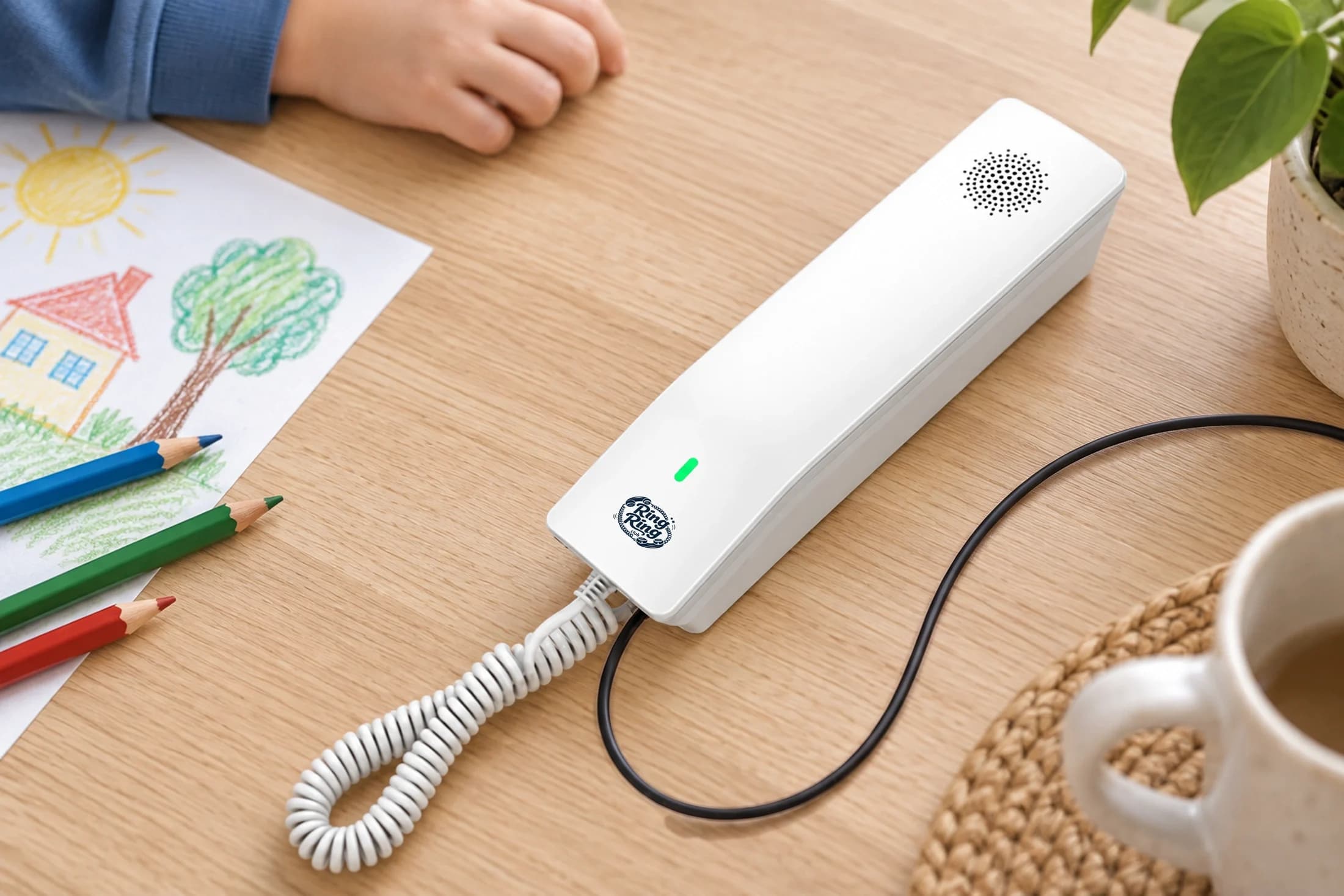 White Ring Ring phone beside a child’s drawing